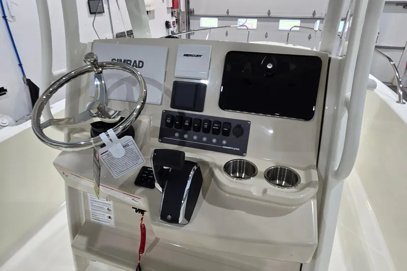 Slide: The Image of 2026 Boston Whaler 220 Dauntless boat console with steering wheel and controls. - 25