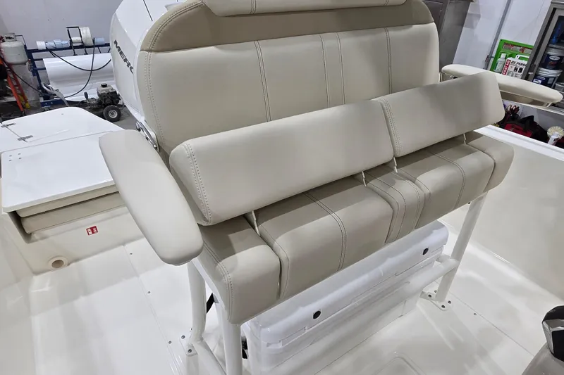 Slide: The Image of 2026 Boston Whaler 220 Dauntless boat interior with beige seating and armrests. - 26