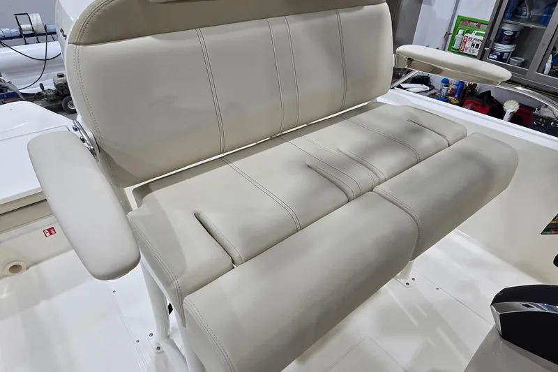 Slide: The Image of 2026 Boston Whaler 220 Dauntless boat seat with beige upholstery and armrests. - 30