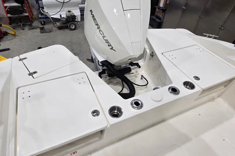 Slide: The Image of 2026 Boston Whaler 220 Dauntless boat with Mercury engine in a workshop setting. - 33