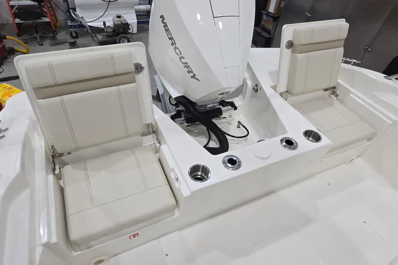 Slide: The Image of 2026 Boston Whaler 220 Dauntless boat interior with Mercury engine and cushioned seating. - 34