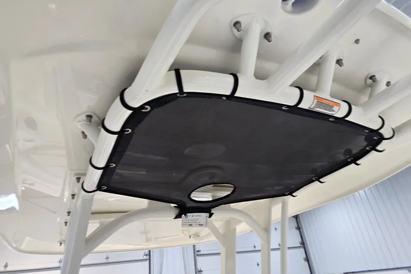 Slide: The Image of 2026 Boston Whaler 220 Dauntless T-top with black canvas, showcasing sturdy construction. - 38