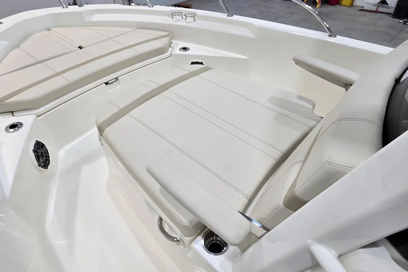 Slide: The Image of 2026 Boston Whaler 220 Dauntless boat interior with cushioned seating and sleek design. - 41