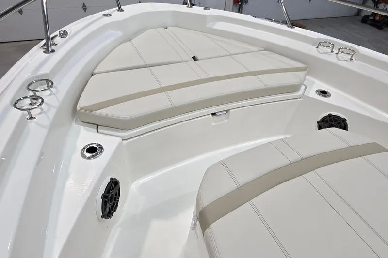 Slide: The Image of 2026 Boston Whaler 220 Dauntless boat interior with cushioned seating and stainless steel fixtures. - 42
