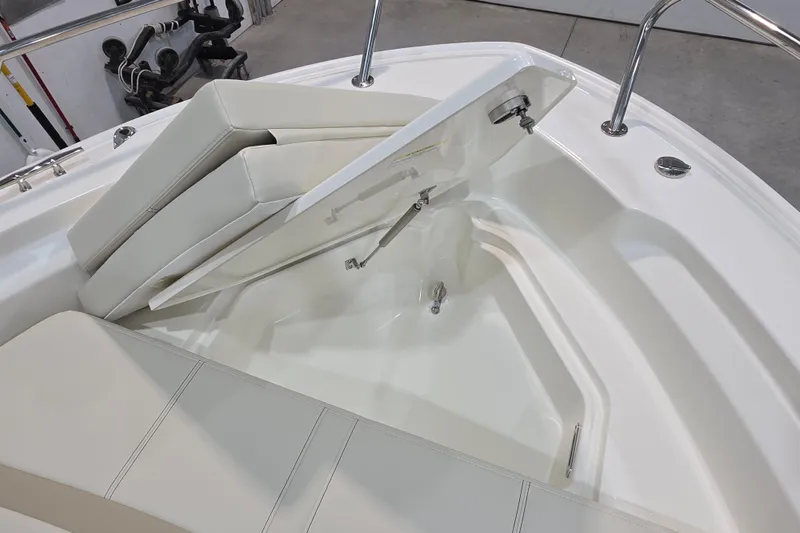Slide: The Image of 2026 Boston Whaler 220 Dauntless boat interior with open storage compartment. - 45