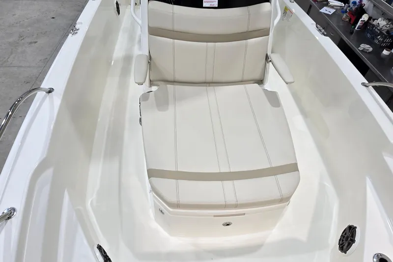 Slide: The Image of 2026 Boston Whaler 220 Dauntless boat interior with cushioned seating and armrests. - 46