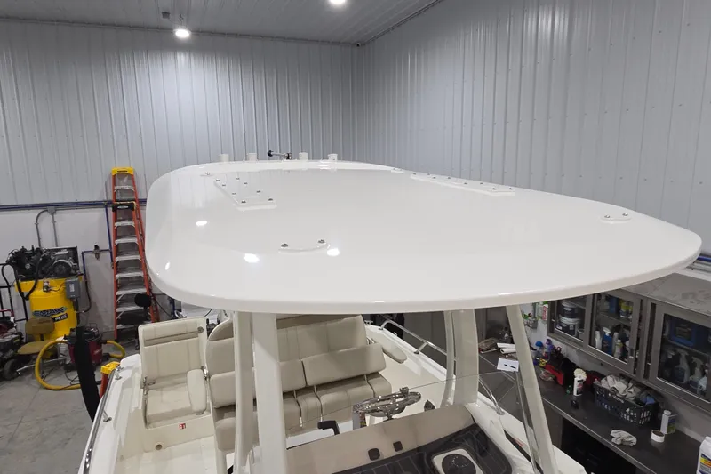 Slide: The Image of 2026 Boston Whaler 220 Dauntless boat in a workshop, showcasing its sleek design. - 47