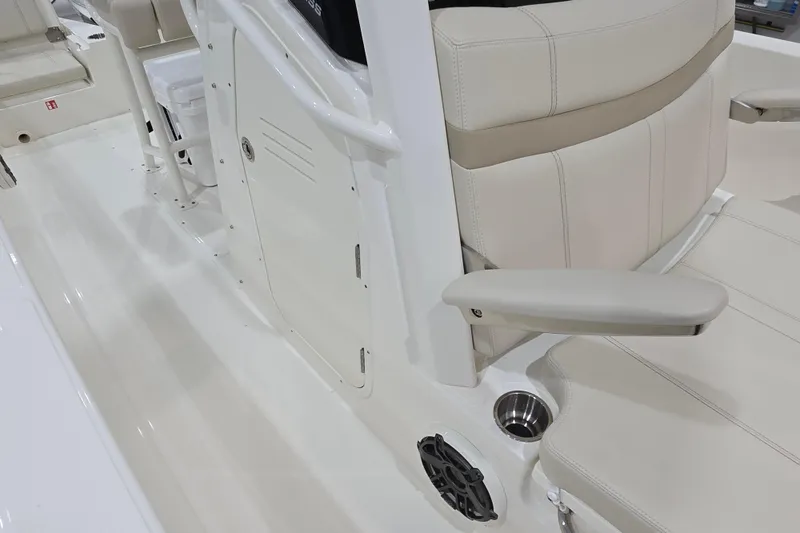 Slide: The Image of 2026 Boston Whaler 220 Dauntless interior with beige seating and armrest. - 49