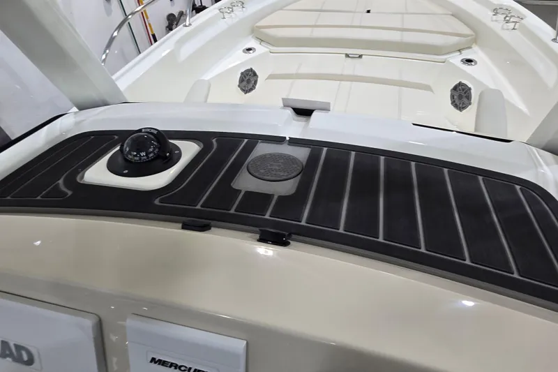 Slide: The Image of 2026 Boston Whaler 220 Dauntless boat deck with compass and seating area. - 51