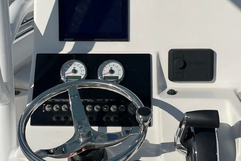 Slide: The Image of 2026 Sailfish 272 CC boat docked at marina, surrounded by other vessels. - 1