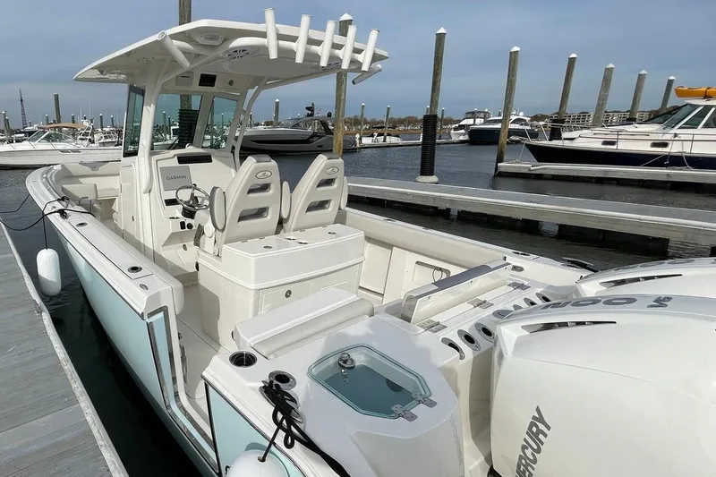 Slide: The Image of 2026 Sailfish 272 CC boat docked, featuring dual Mercury engines and modern seating. - 12