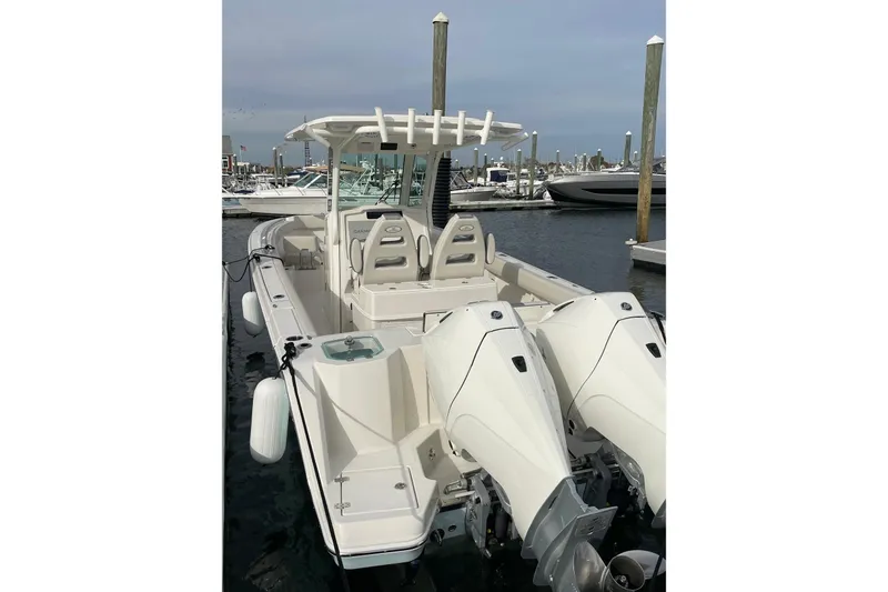 Slide: The Image of 2026 Sailfish 272 CC boat with dual engines docked at marina. - 13