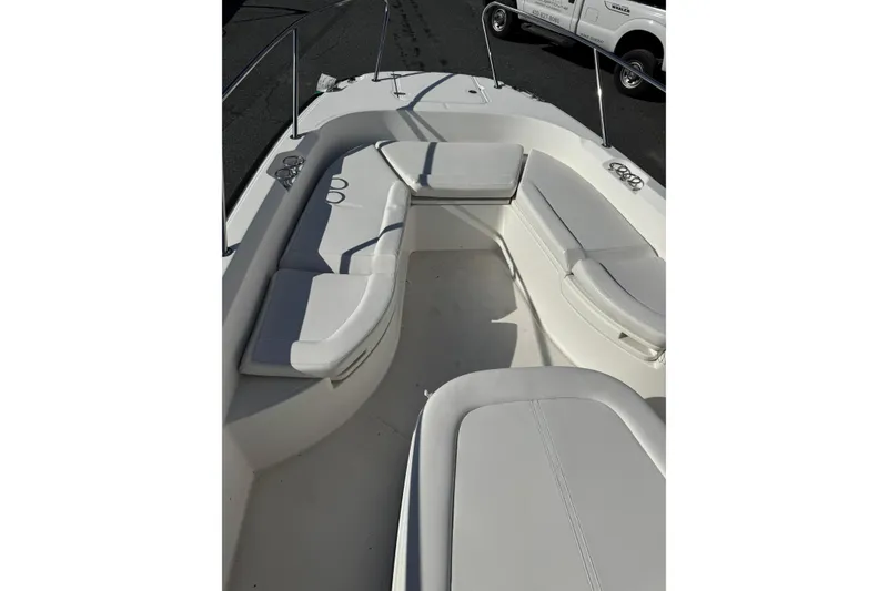 Slide: The Image of 2014 Boston Whaler 270 Dauntless boat interior with cushioned seating and cup holders. - 17