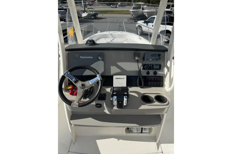 Slide: The Image of 2014 Boston Whaler 270 Dauntless helm with steering wheel, controls, and navigation equipment. - 18