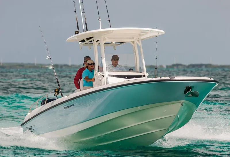 Slide: The Image of Manufacturer Provided Image: 2014 Boston Whaler 270 Dauntless boat cruising on the water with passengers. - 4