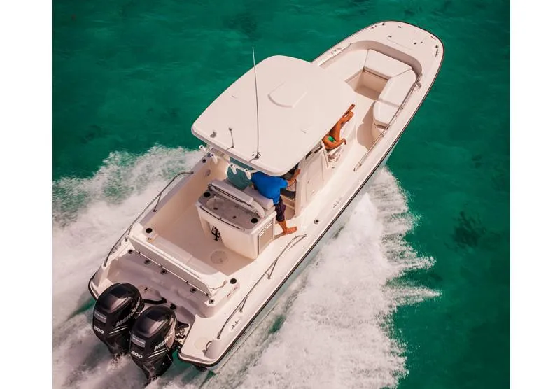 Slide: The Image of Manufacturer Provided Image: 2014 Boston Whaler 270 Dauntless boat cruising on clear turquoise water. - 6