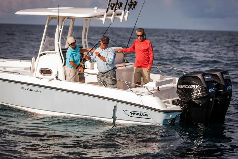 Slide: The Image of Manufacturer Provided Image: 2014 Boston Whaler 270 Dauntless boat with people fishing on the ocean. - 7