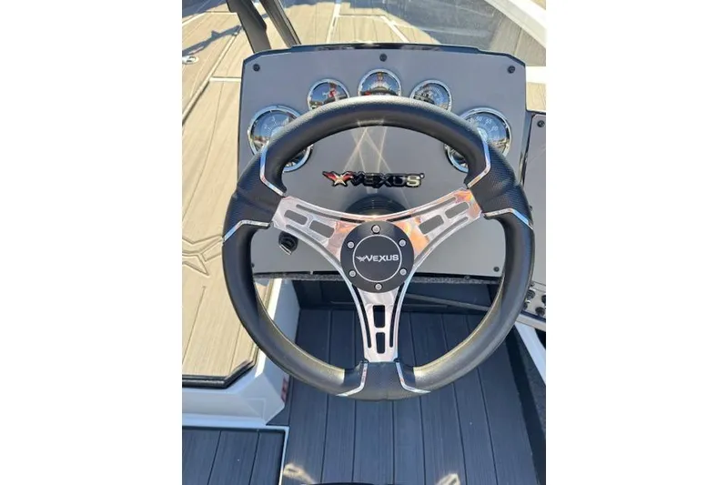 Slide: The Image of Steering wheel of 2026 Vexus ADX 190 boat with dashboard gauges. - 11