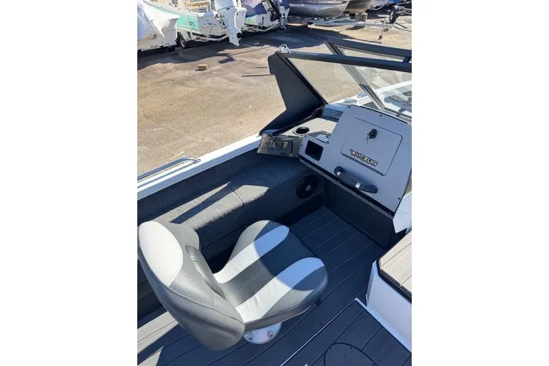 Slide: The Image of 2026 Vexus ADX 190 boat interior with steering console and cushioned seat. - 13