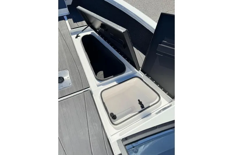 Slide: The Image of 2026 Vexus ADX 190 boat storage compartments with open lids, showcasing interior space. - 17
