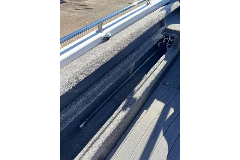 Slide: The Image of 2026 Vexus ADX 190 boat interior storage compartment with rod holders. - 20