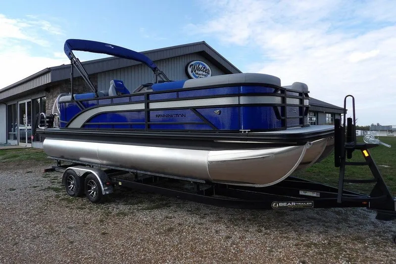 The Image of 2026 Bennington S Quad Bench 22 SSR pontoon boat on trailer, parked outside dealership. - 1