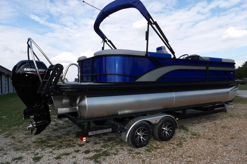 Slide: The Image of 2026 Bennington S Quad Bench 22 SSR pontoon boat with Mercury engine on trailer. - 10