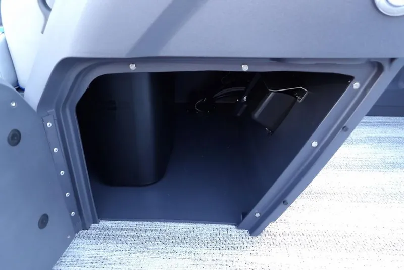 Slide: The Image of 2026 Bennington S Quad Bench 22 SSR interior with blue and gray seating and steering console. - 21