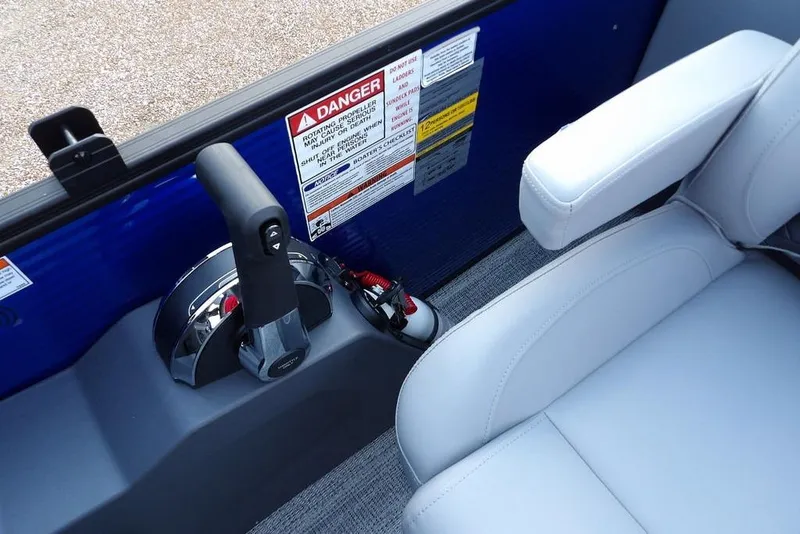 Slide: The Image of 2026 Bennington S Quad Bench 22 SSR boat interior with control lever and safety warnings. - 32