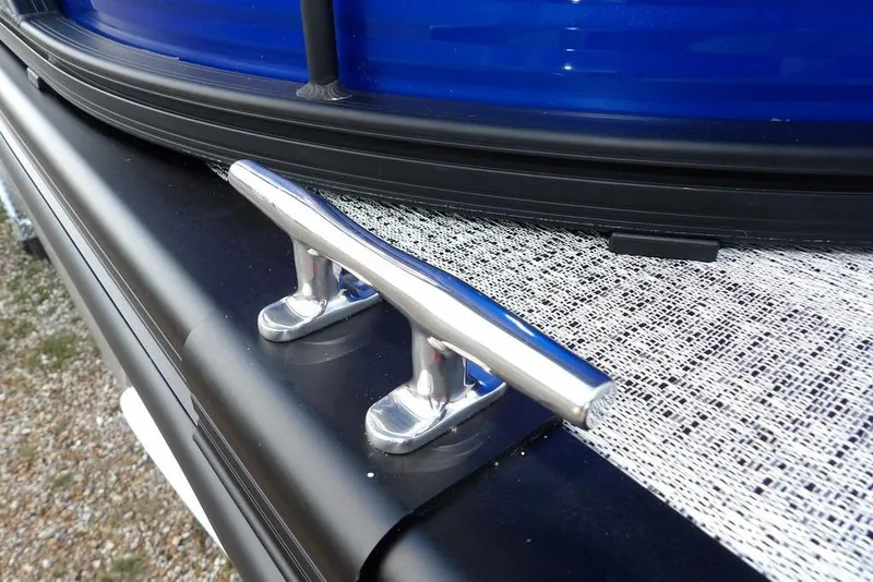 Slide: The Image of 2026 Bennington S Quad Bench 22 SSR on Bear Trailer, parked on gravel near a building. - 40