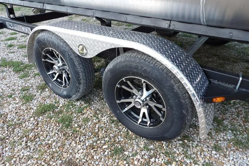Slide: The Image of 2026 Bennington S Quad Bench 22 SSR trailer on gravel surface. - 44