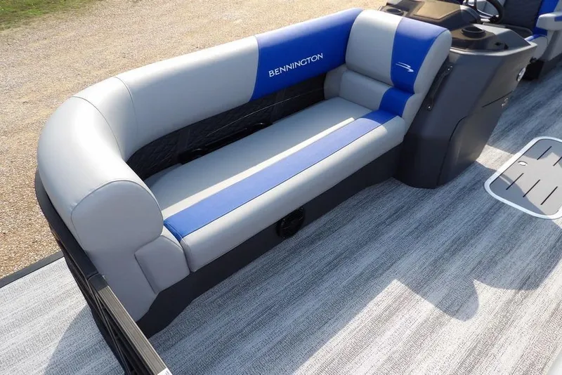 Slide: The Image of 2026 Bennington S Quad Bench 22 SSR with blue and gray seating on a boat deck. - 8