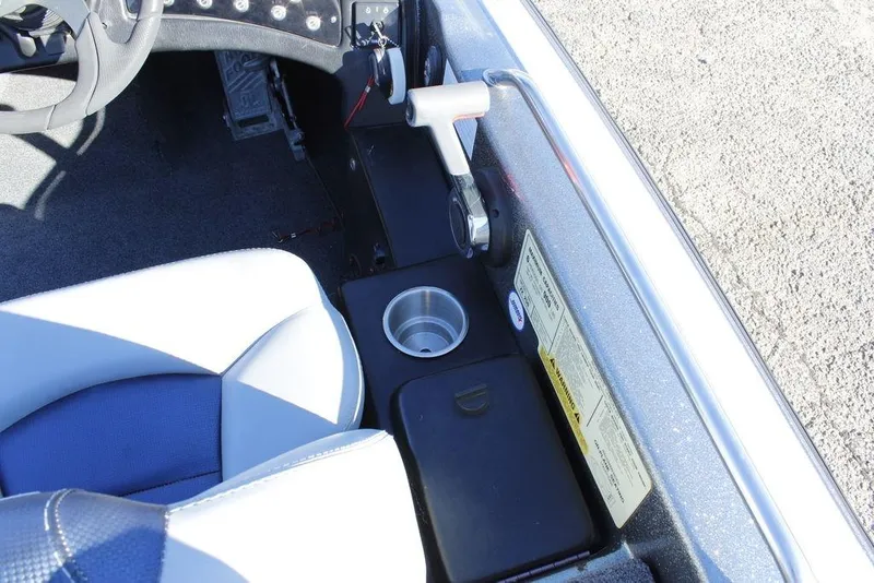 Slide: The Image of Interior of a 2003 Skeeter ZX250 boat showing seat, cup holder, and control panel. - 13