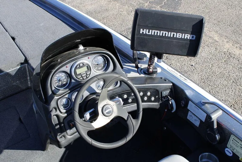 Slide: The Image of 2003 Skeeter ZX250 boat dashboard with steering wheel and Humminbird fish finder. - 14
