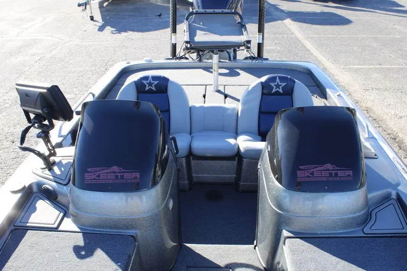 Slide: The Image of 2003 Skeeter ZX250 boat interior with dual consoles and seating. - 15