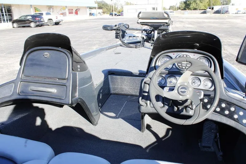 Slide: The Image of 2003 Skeeter ZX250 boat dashboard with steering wheel and instrument panel. - 19