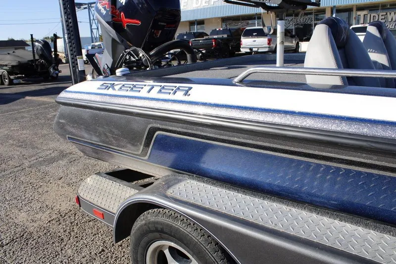 Slide: The Image of 2003 Skeeter ZX250 boat on trailer, featuring sleek design and metallic finish. - 2
