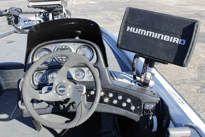 Slide: The Image of 2003 Skeeter ZX250 boat dashboard with steering wheel and Humminbird fish finder. - 20