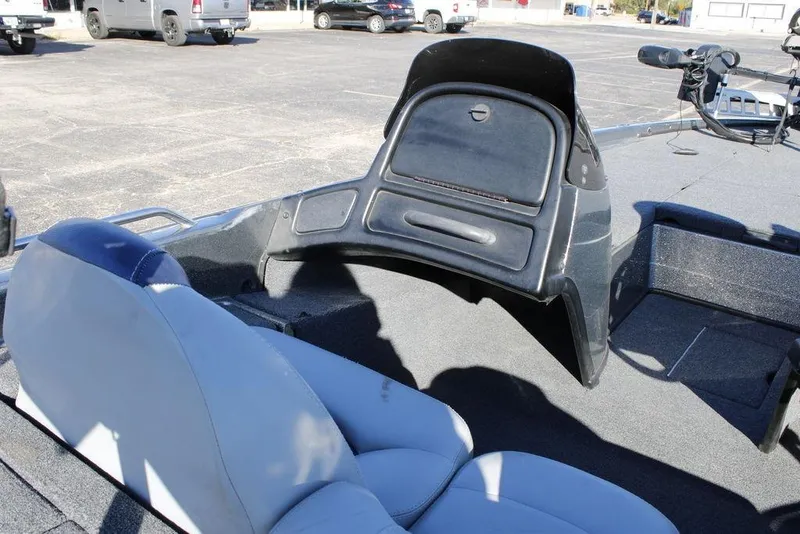 Slide: The Image of 2003 Skeeter ZX250 boat interior with seating and dashboard in a parking lot. - 24