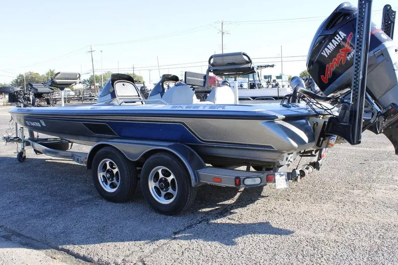 Slide: The Image of 2003 Skeeter ZX250 boat with Yamaha engine on a trailer in a parking lot. - 25