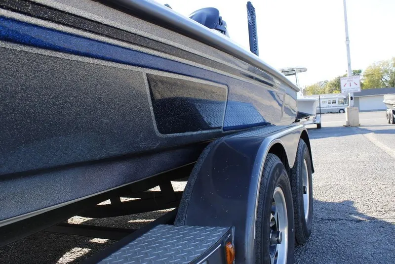 Slide: The Image of 2003 Skeeter ZX250 boat on trailer, close-up side view in parking lot. - 28