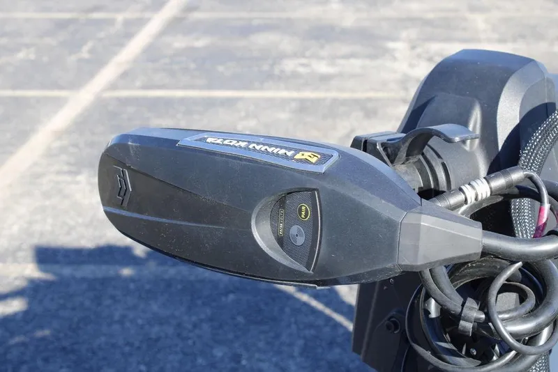 Slide: The Image of Close-up of a 2003 Skeeter ZX250 boat motor component in a parking lot. - 3