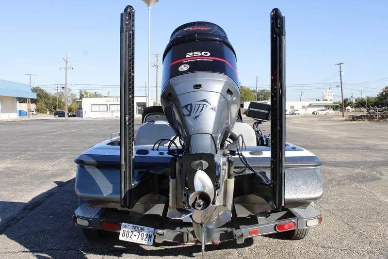 Slide: The Image of 2003 Skeeter ZX250 boat with powerful outboard motor, parked in a lot. - 5