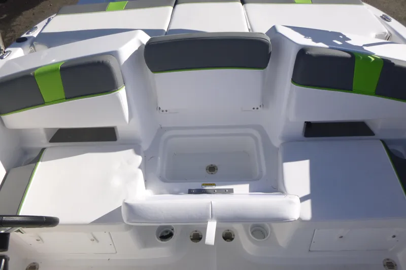Slide: The Image of 2024 Tahoe T18 boat interior with white and green cushioned seating. - 10