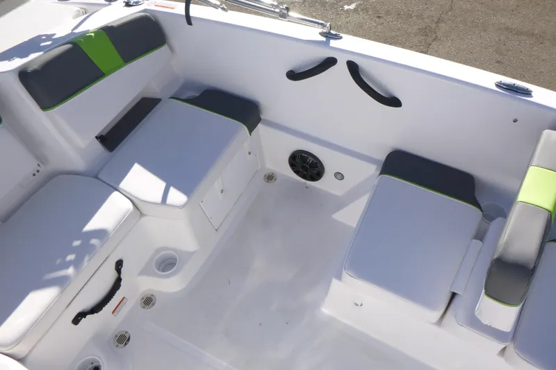 Slide: The Image of 2024 Tahoe T18 boat interior with cushioned seating and storage compartments. - 12