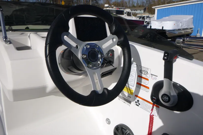 Slide: The Image of 2024 Tahoe T18 boat steering wheel and controls, featuring modern design and safety labels. - 15
