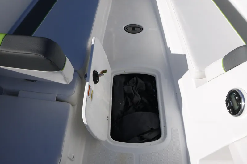 Slide: The Image of 2024 Tahoe T18 boat interior storage compartment with open hatch and seating. - 19