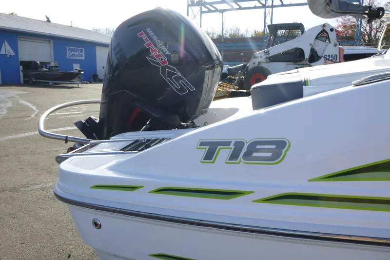 Slide: The Image of 2024 Tahoe T18 boat with Mercury Pro XS engine in a marina setting. - 2