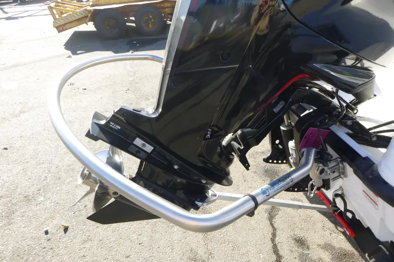 Slide: The Image of 2024 Tahoe T18 boat engine with protective guard on a sunny day. - 3