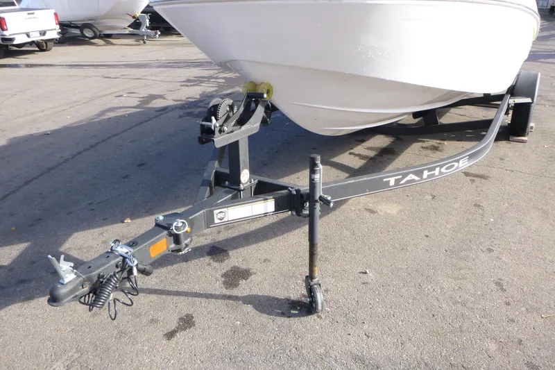Slide: The Image of 2024 Tahoe T18 boat trailer hitch on pavement, showcasing sturdy design. - 6